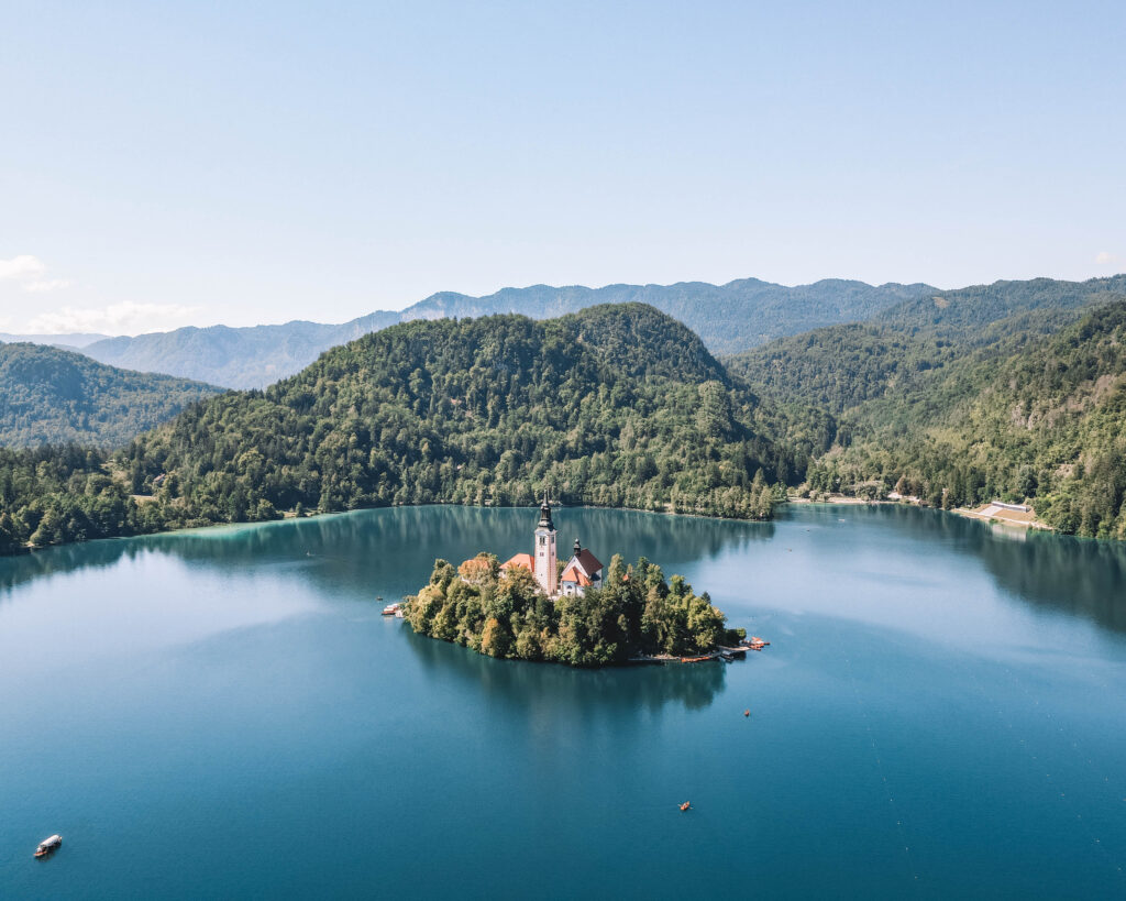 island surrounded by blue water in Lake Bled, Slovenia