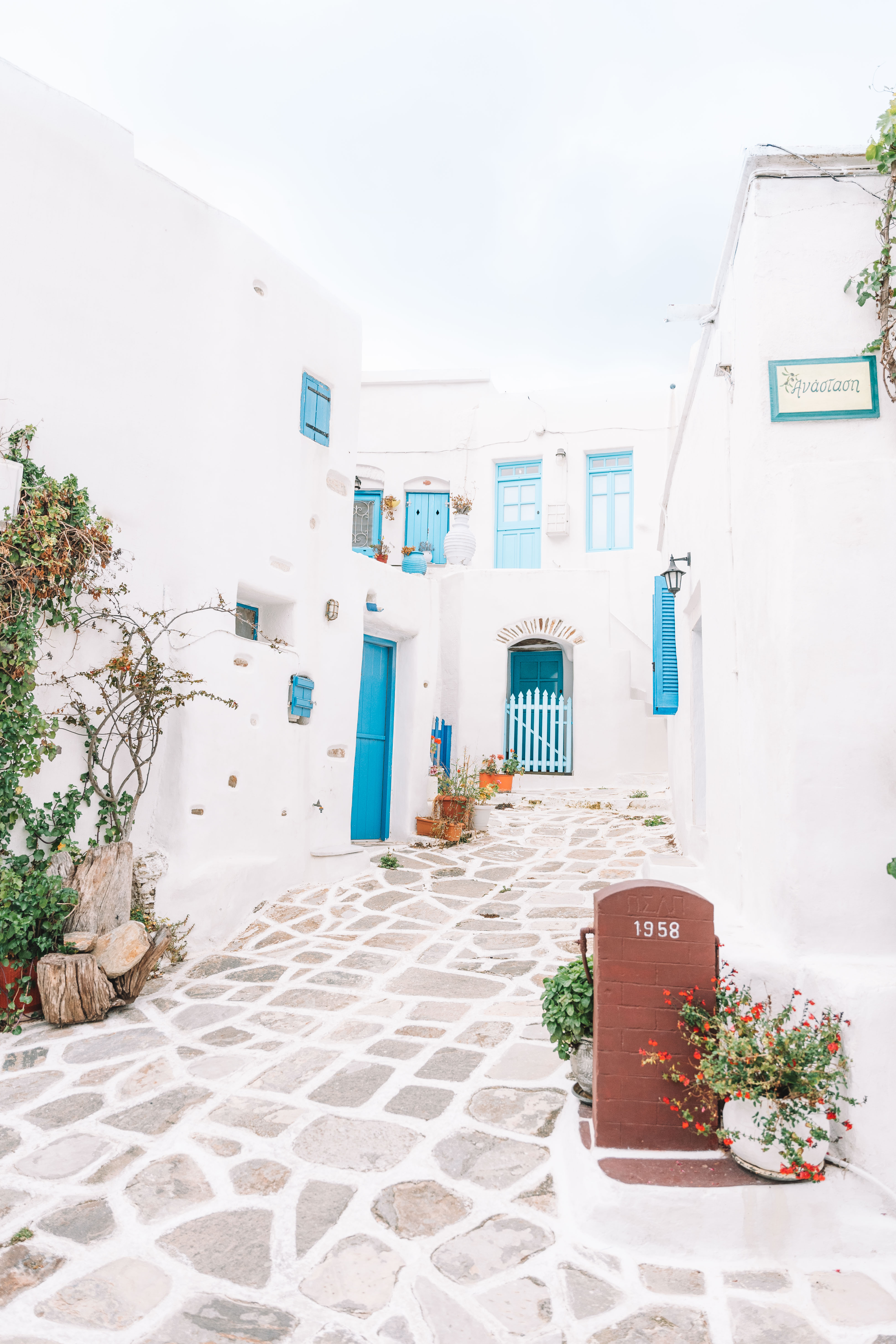 white washed buildings with blue doors in Paros Greece 2 week itinerary