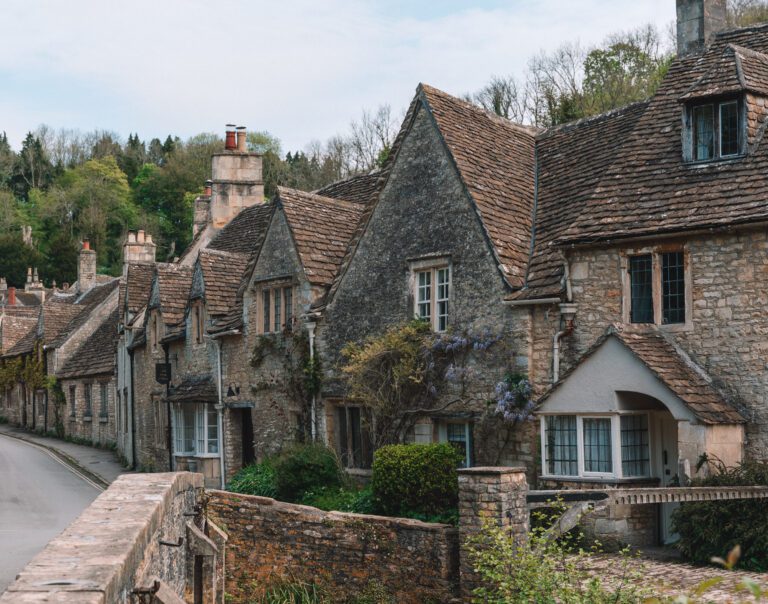 stone buildings covered in ivy and wisteria in The Cotswolds, England