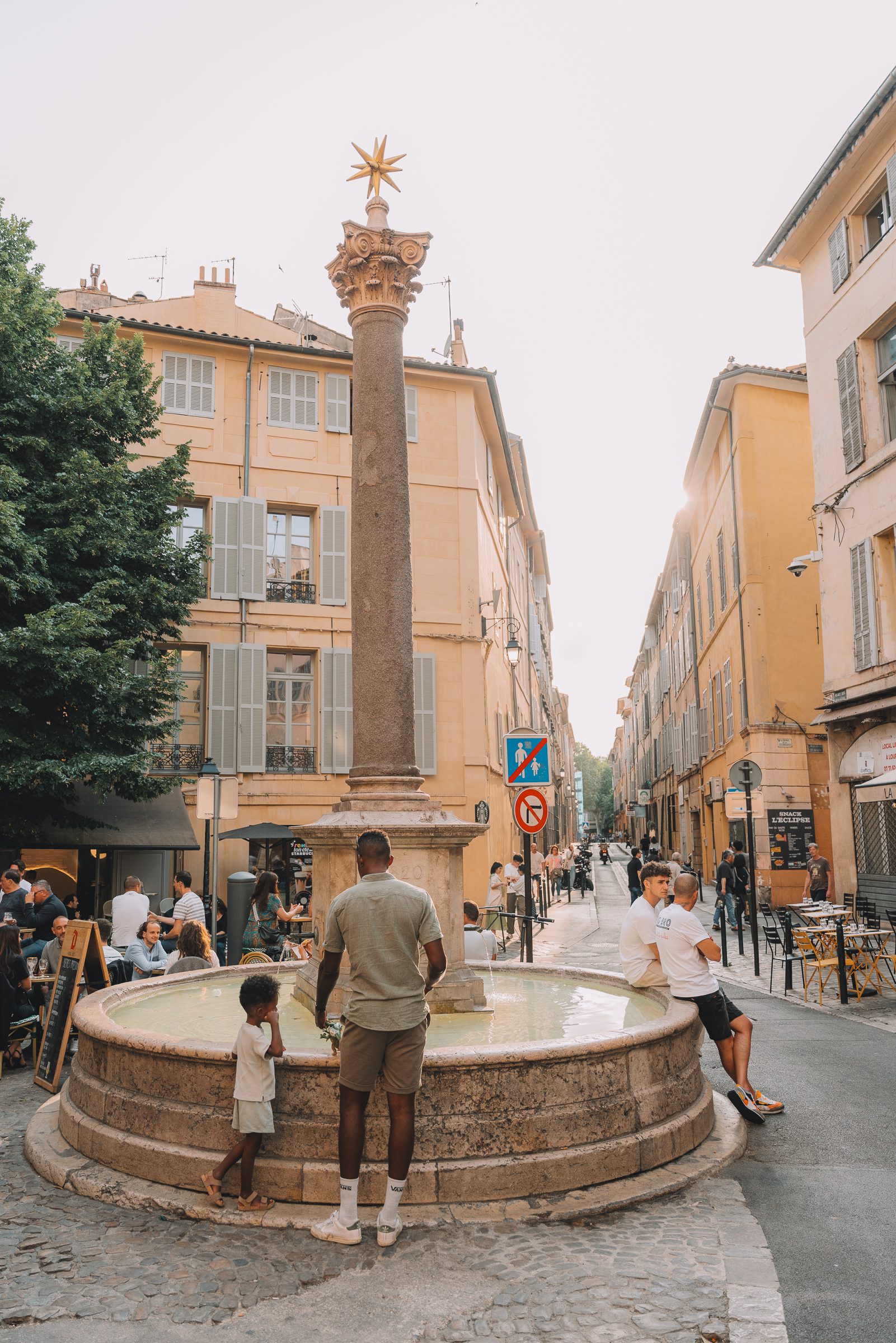 people gathered around a fountain in Aix-en-Provence, France 10 Day South of France itinerary