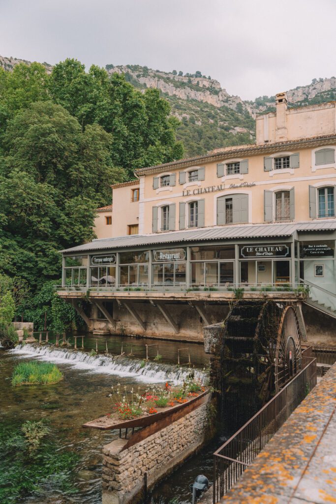 waterwheel and shops built over La Sorgue in Fontaine-de-Vaucluse, Provence, France