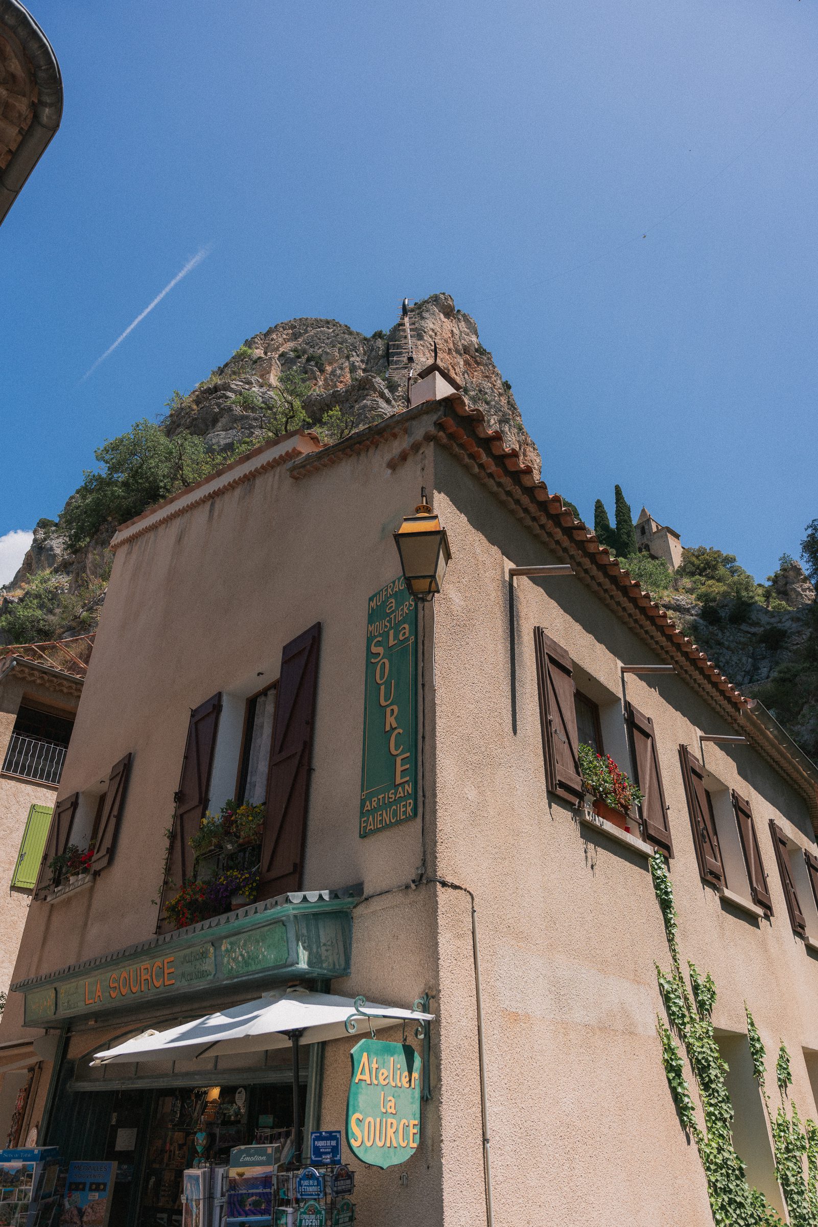 building and mountains in Moustiers-Sainte-Marie, France